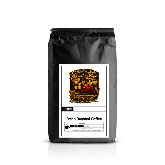 Caffeine Joe's Mountain Brew Honduras coffee bag with label featuring mountain imagery and branding.
